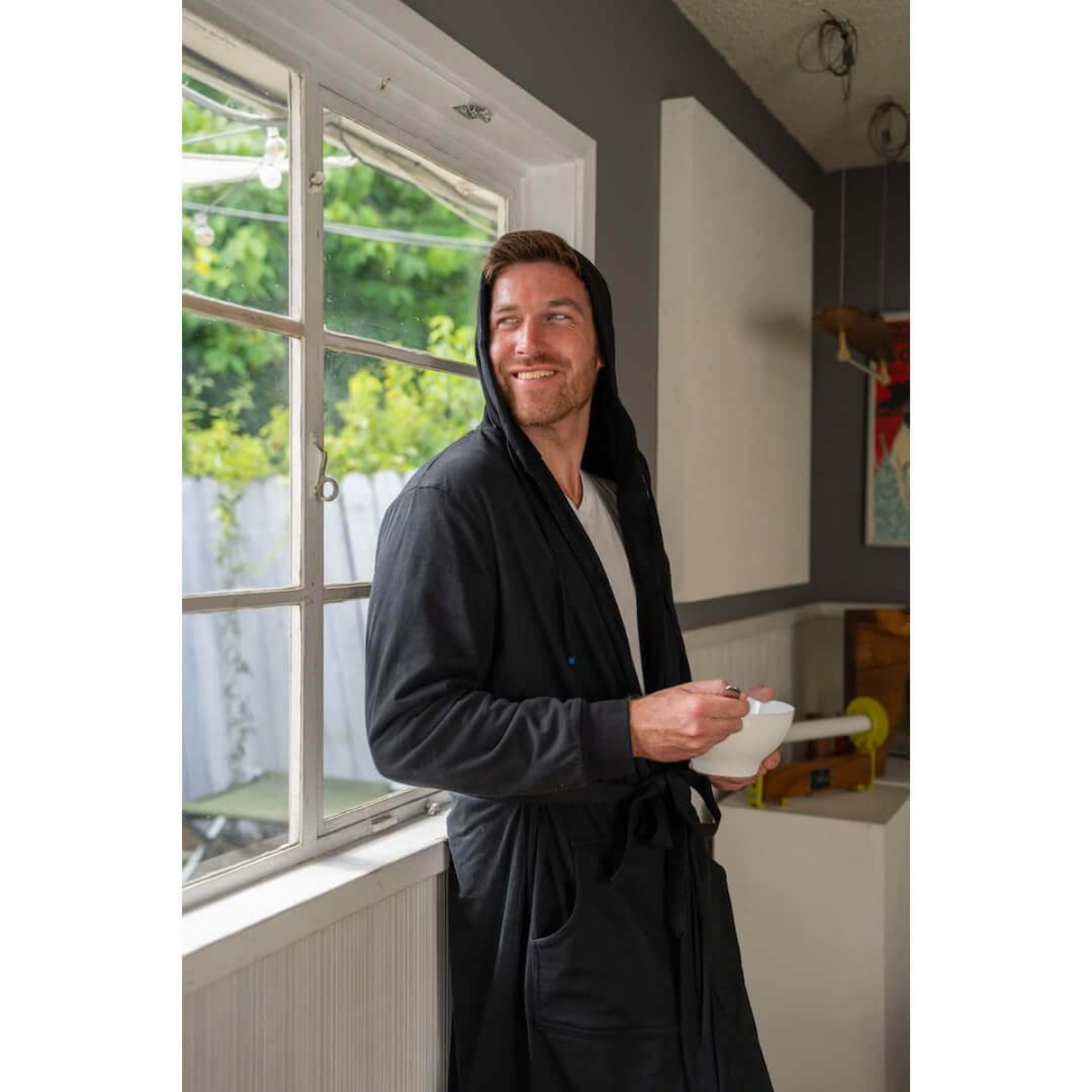 Man relaxing on couch wearing DudeRobe